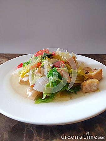 Delicious and tasty stir-fry cabbage with tofu on a white plate Stock Photo