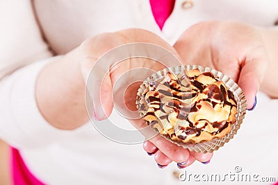 Delicious sweet cupcake in human hands. Gluttony Stock Photo