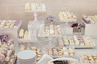 Delicious & tasty white decorated cupcakes at wedding reception Stock Photo