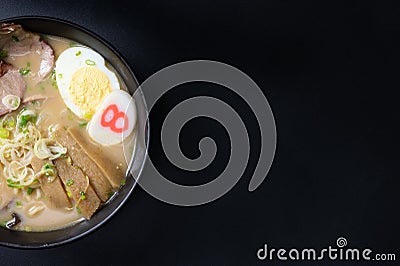Delicious tonkotsu ramen, Japanese noodle in pork Bone based soup topped with chashu pork, boiled egg, pickled bamboo shoot Stock Photo