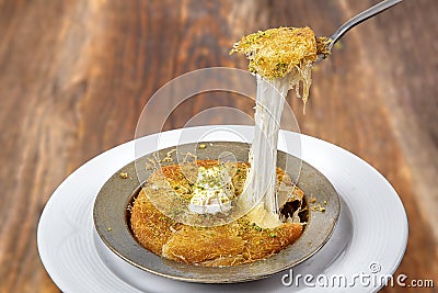 Delicious traditional Turkish dessert: Kunefe kadayif with pistachio and cheese Stock Photo