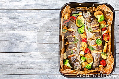 Delicious trout fish grilled with potatoes, broccoli, lemon Stock Photo