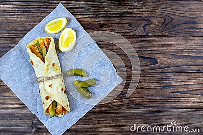 Delicious Turkish doner kebab on pita bread with shaved roasted meat off a traditional vertical rotisserie served with fresh salad Stock Photo