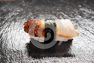 Delicious unagi eel nigiri sushi on black background. Eel Sushi. Traditional Japanese cuisine Stock Photo