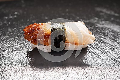 Delicious unagi eel nigiri sushi on black stone background. Eel Sushi. Traditional Japanese cuisine Stock Photo