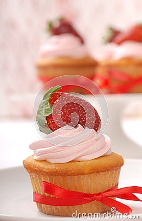 Delicious Vanilla cupcake with strawberry frosting Stock Photo