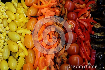 Delicious vegetables in brown, orange, orange and yellow, fire colors on a plate, eggplant, yellow and orange tomatoes, Stock Photo