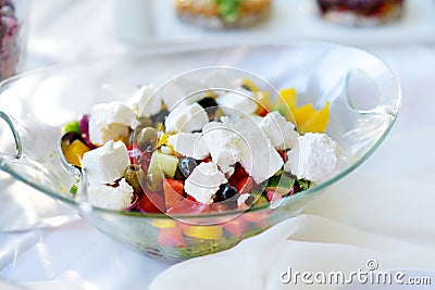 Delicious vegetables and goat cheese salad served on a party or wedding reception Stock Photo