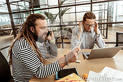 Delighted bearded man working in the office Stock Photo