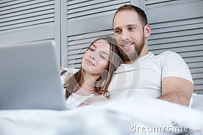 Delighted couple watching a film together Stock Photo