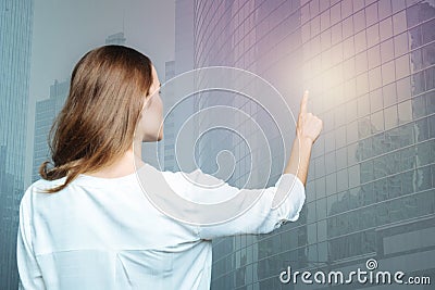 Delighted nice woman looking at the sensory screen Stock Photo