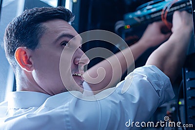 Delighted positive IT administrator enjoying his job Stock Photo