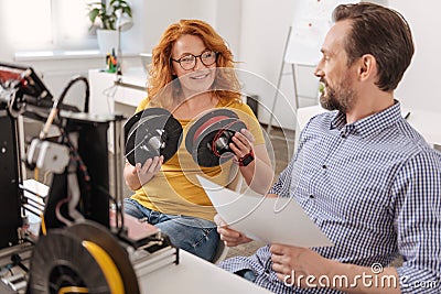 Delighted positive woman holding two filament coils Stock Photo