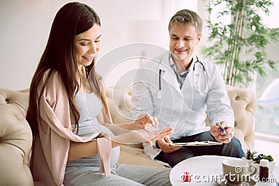 Delighted pregnant woman taking medicine Stock Photo