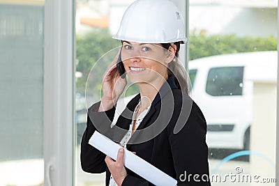 Delighted professional female engineer on phone Stock Photo