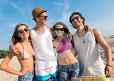 Delighted smiling friends having fun on the beach Stock Photo