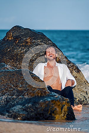 Cheerful man on seashore in summer Stock Photo