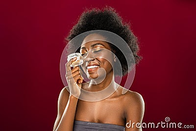 Delighted young woman using organic facial cream Stock Photo