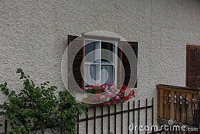 Delightful floral decoration in front of a window in a village house. Stock Photo