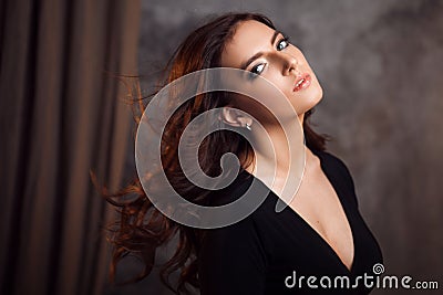 Delightful portrait of a woman brunettes, hair flying on the wind, sloppy styling Stock Photo