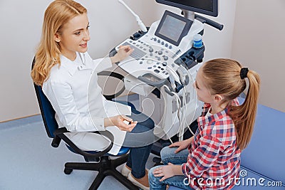 Delightful practitioner consulting little girl in the sonography cabinet Stock Photo