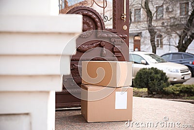 Delivered parcel boxes near open door Stock Photo