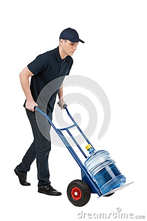 Delivering water. Cheerful young going carrying a hand truck wit Stock Photo