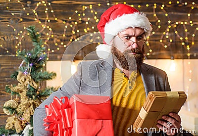 Delivery christmas present. Christmas gift. Man santa hat hold gift. Delivery service. Spread happiness and joy. Bearded Stock Photo
