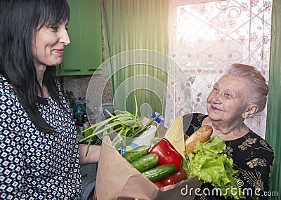 Delivery food during virus outbreak, coronavirus panic and pandemics. Stay safe at Home. Social worker helps retirees in the Stock Photo