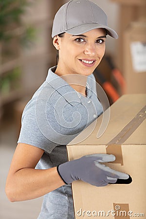 delivery girl wearing uniform holding box Stock Photo