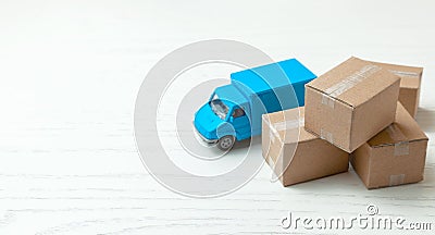 Delivery of goods from online stores. Day moving. Truck and cardboard boxes. Copy space for text. Stock Photo