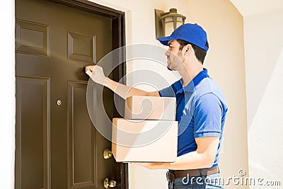 Delivery guy knocking on the door Stock Photo