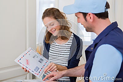 Delivery man handing over a registered mail Stock Photo