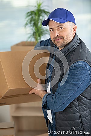 delivery man holding and carrying cardbox Stock Photo