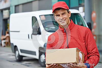 Delivery man with package outdoors Stock Photo