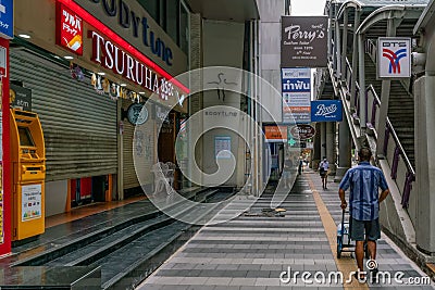 Delivery man pushes a trolley at Silom street next to Saladaeng Bts Station in Bangkok, Thailand. Editorial Stock Photo