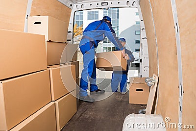 Delivery Men Loading Cardboard Boxes Stock Photo