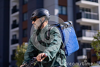 delivery person riding electric bicycle Stock Photo