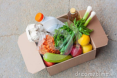 Delivery during quarantine o food donation concept. Box with vegetables, fruits and food. Assistance at quarantine time Stock Photo