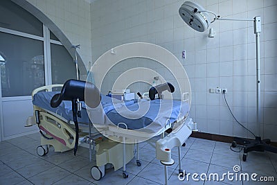 Delivery room of a maternity hospital, obstetric bed, lamp, medical equipment set Stock Photo