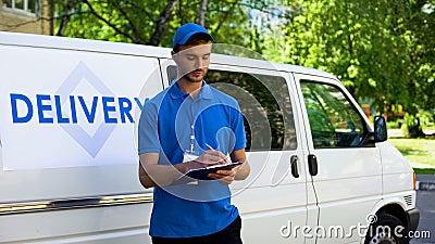 Delivery service worker filling warranty card, part-time job, occupation Stock Photo