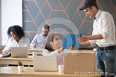 Deliveryman asking woman sign documents after package delivery i Stock Photo