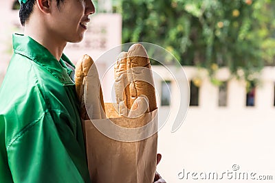 deliveryman hold bakery bag snd wait for pick up Stock Photo