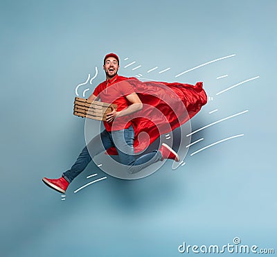 Deliveryman with pizzas acts like a powerful superhero. Concept of success and guarantee on shipment. Studio cyan Stock Photo