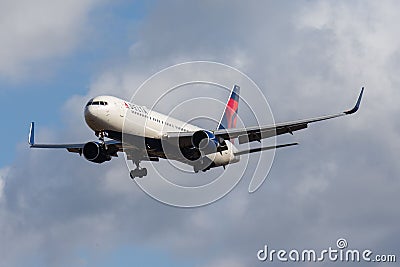 Delta Airlines Boeing 767-332 isolated in the air with clouds in the background Editorial Stock Photo