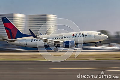 Delta commercial Jet taking off at John Wayne Airport with blurred background Editorial Stock Photo