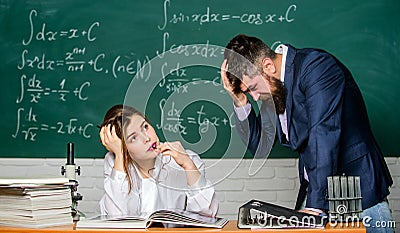 Demanding lecturer. Teacher strict serious bearded man having conflict with student girl. Rebuke and punishment. You Stock Photo