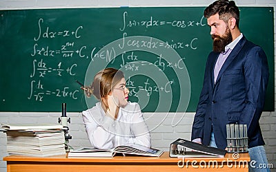 Demanding lecturer. Teacher strict serious bearded man having conflict with student girl. Man unhappy communicating Stock Photo