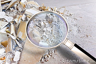 Demolished plasterboard wall, made of plaster and cardboard, with fragments of material and dust in a construction site Stock Photo