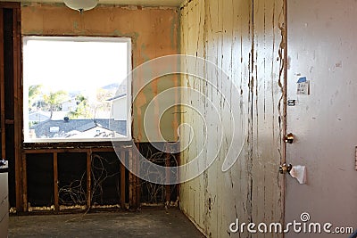 Demolition of paneling off interior wall Stock Photo